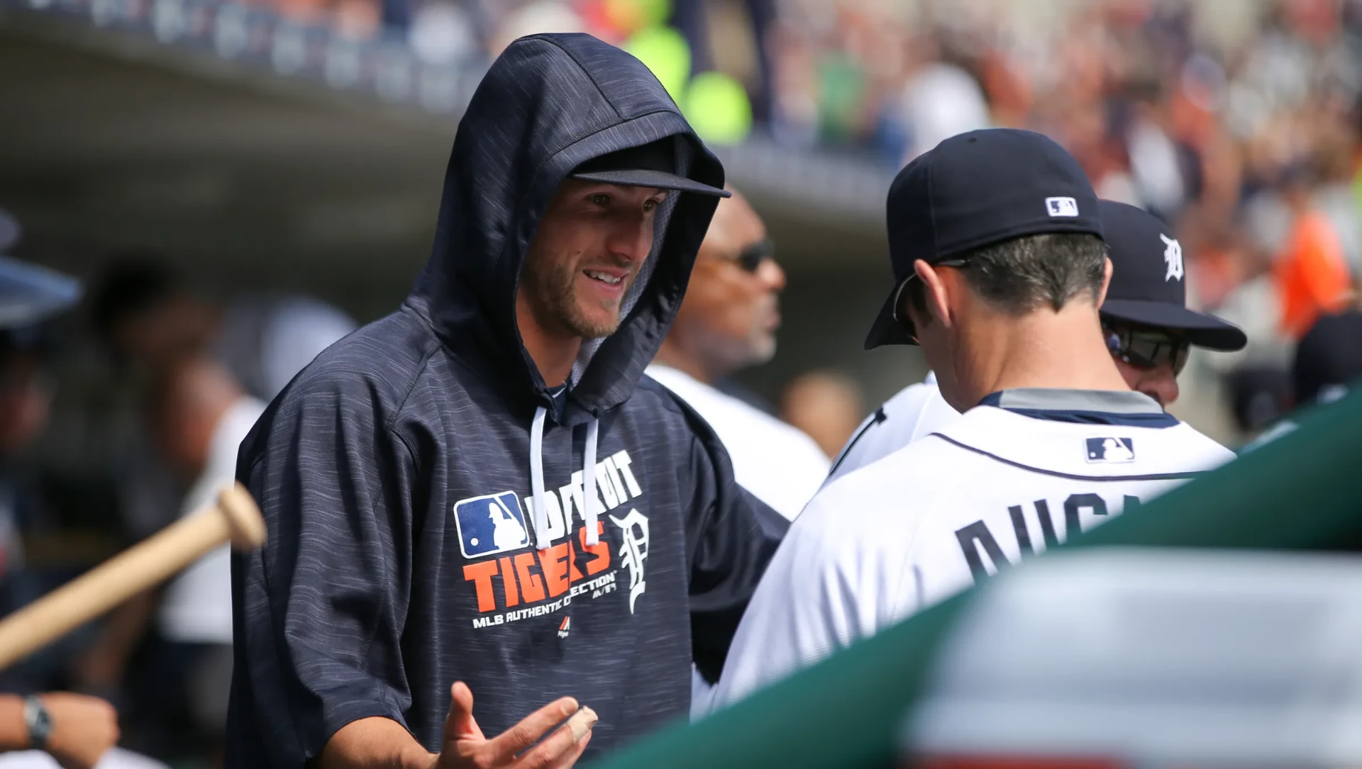 Shane Greene smiling with teammates in the Detroit Tigers dugout
